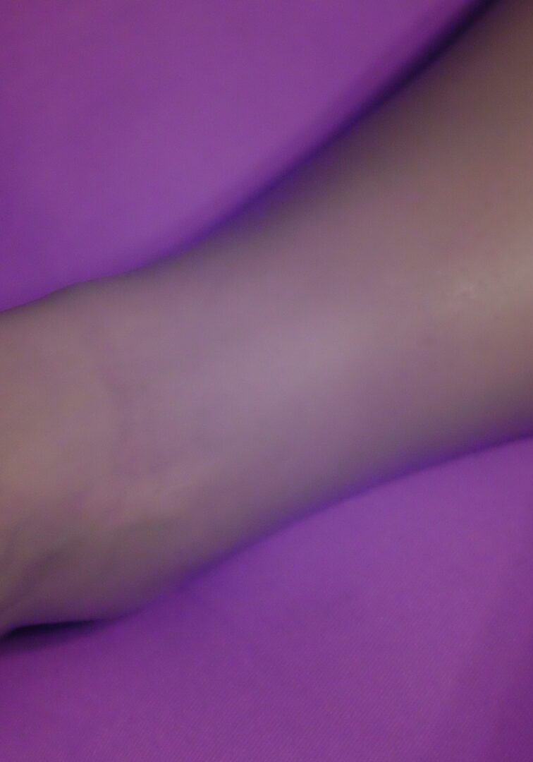 IMG_0465 A person 's foot on top of purple blanket.